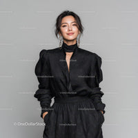Elegant Woman in Black Dress with Jewelry in Studio Portrait