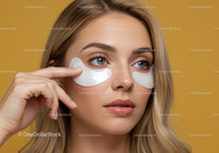 Woman Applying Under Eye Patches with Clear Blue Eyes and Flawless Skin
