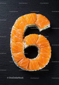 Salmon sushi roll shaped as number six on black surface