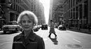 Elegant Elderly Woman Walking in Business District on City Street