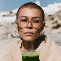 Young Woman Drinking Green Juice Outdoors in Summer