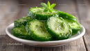 Freshly Sliced Cucumbers with Herbs on a White Plate