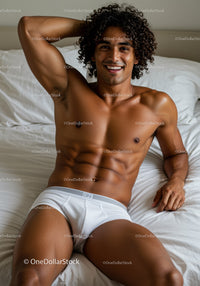 Smiling young man relaxing on white bed in underwear