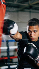 Focused boxer throwing a powerful punch during training