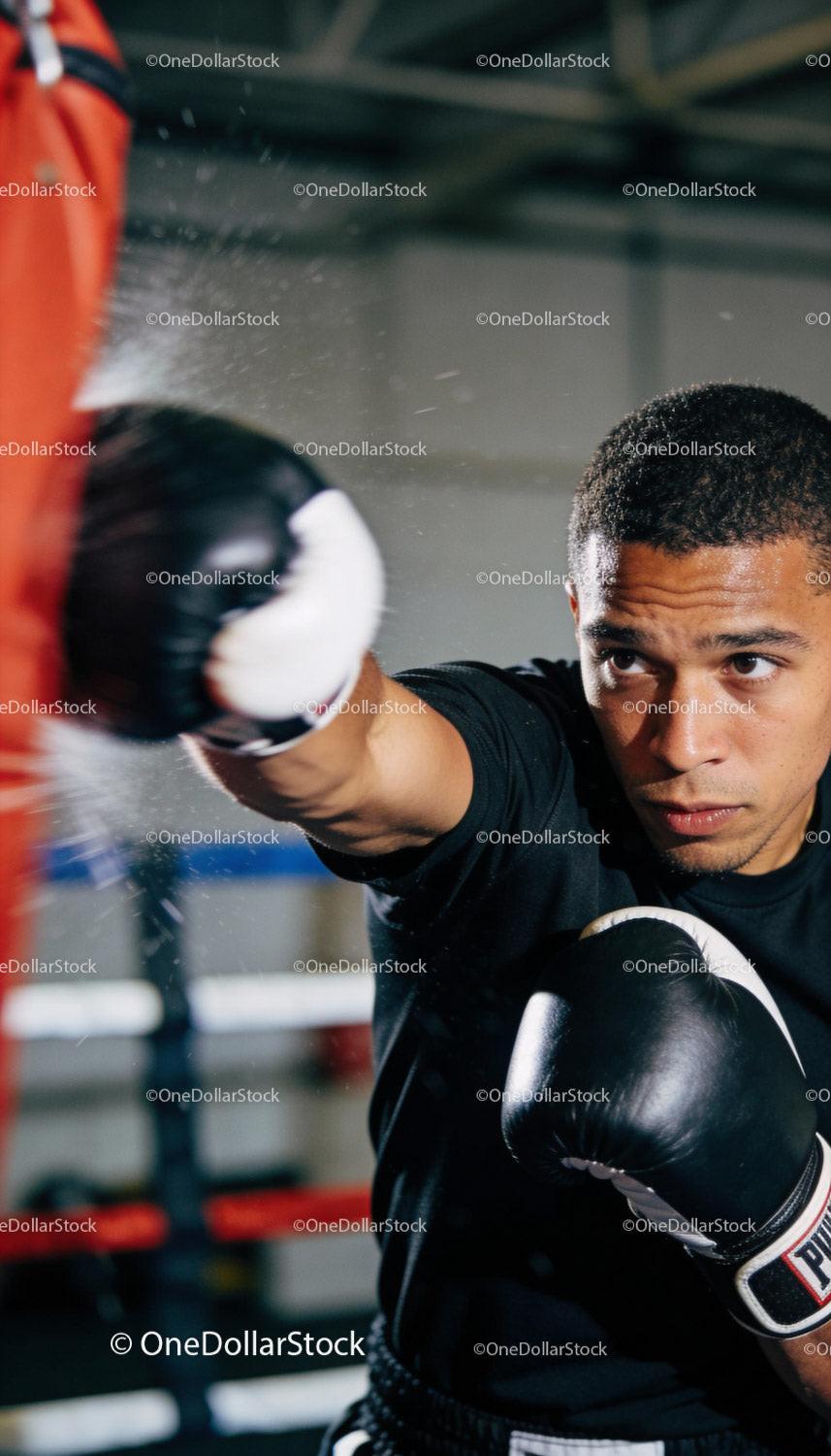 Focused boxer throwing a powerful punch during training