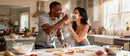Couple Playfully Baking Heart-Shaped Cookies Together