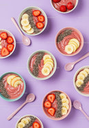 Fresh Fruit Topped Smoothie Bowls on Violet Background