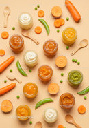 Jars of colorful baby food with fresh vegetables