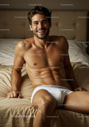 Smiling Fit Man Relaxing on Bed in White Underwear