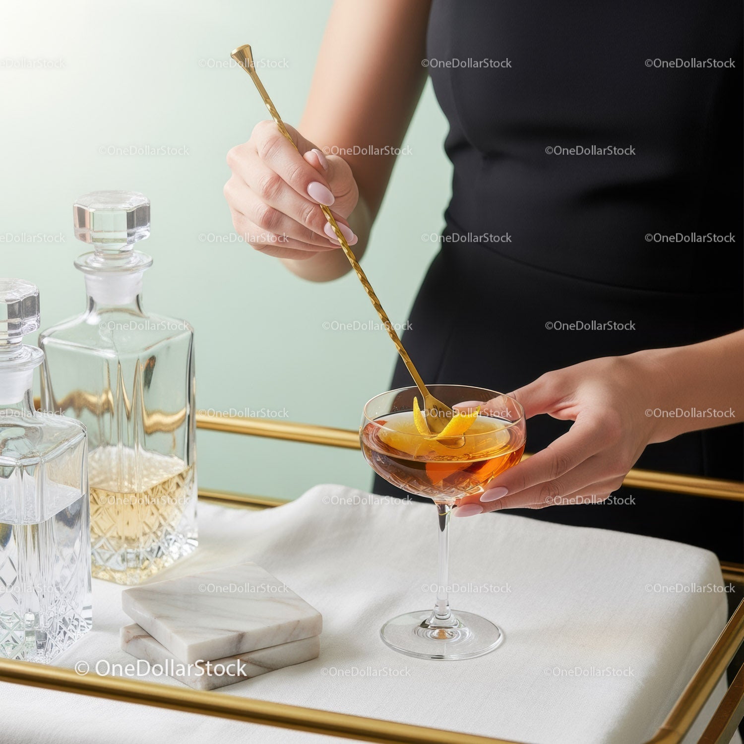 Elegant Cocktail Mixing Scene with Gold Stirring Stick and Stylish Glassware