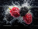 Splashing Fresh Raspberries and Blackberries in Water