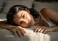 Close-up of Beautiful Woman Lying on Cozy Sofa with Warm Lighting