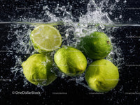 Vibrant Fresh Lime Sliced Splashing into Water with Droplets