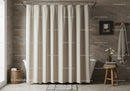 Beige Shower Curtain and Stone-Tiled Bathroom with Wooden Stool