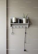 Minimalist Wall Shelf with White and Black Vases and Green Plant