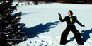 Woman in bold black suit posing in snowy landscape