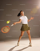 Female tennis player striking a forehand shot indoors