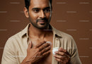 Man Applying Moisturizer to Chest with Skincare Products