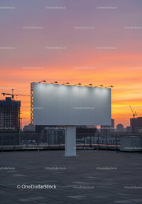 Empty Billboard on Rooftop Against Colorful Sunset Sky
