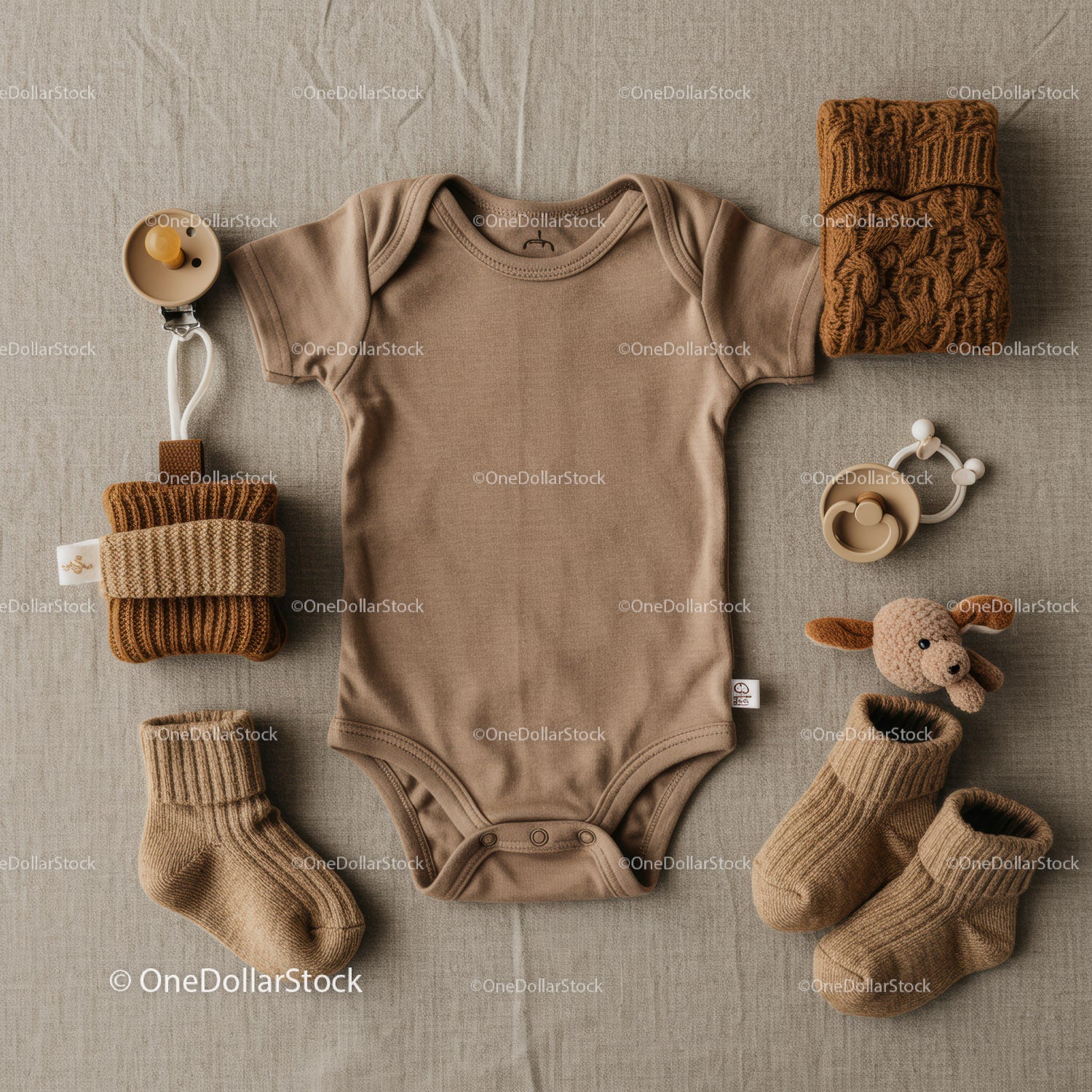 Neutral baby clothing and accessories flat lay arrangement