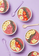 Colorful smoothie bowls with fresh fruit and chia seeds
