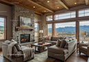 Cozy living room with stone fireplace and mountain view