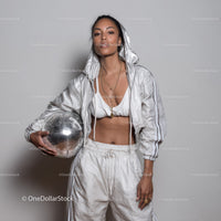 Stylish Woman in Metallic Outfit Holding Disco Ball for Modern Fashion