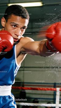 Focused boxer delivering a powerful punch in the ring