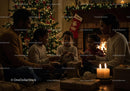 Family enjoying cozy Christmas evening by the fireplace