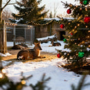 Peaceful deer resting beside decorated Christmas tree