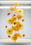 Banana slices and peanuts drizzled with honey flowing