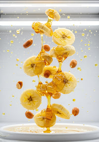 Banana slices and peanuts drizzled with honey flowing
