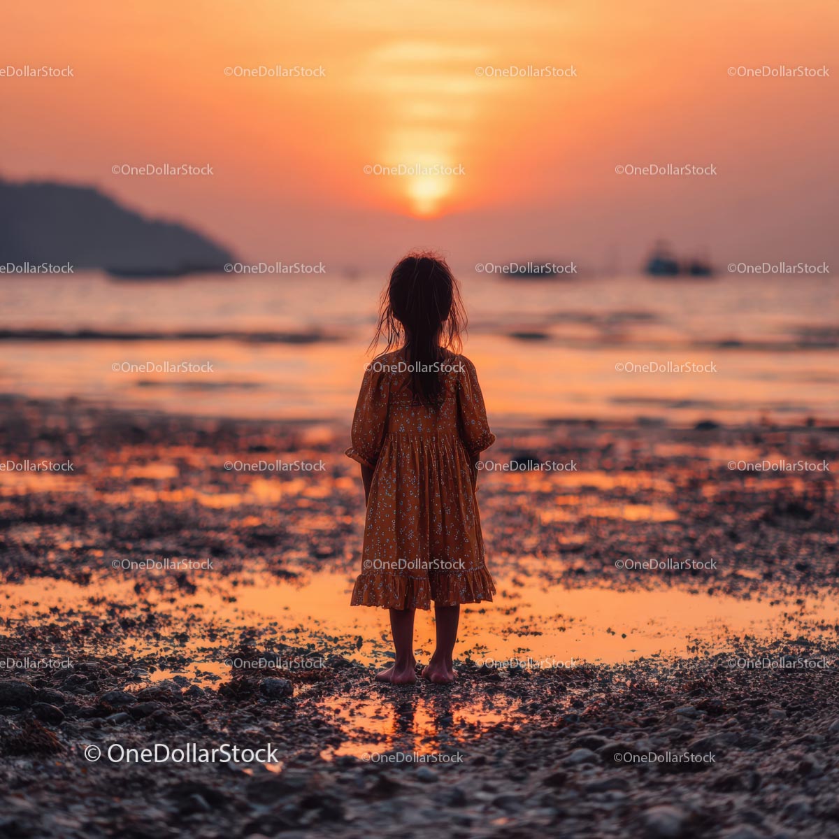 Silhouette of a Child at Sunset by the Ocean Shore
