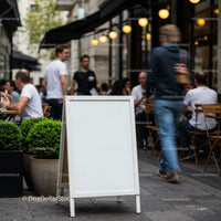 Blank Street Sign Outside Busy Urban Cafe