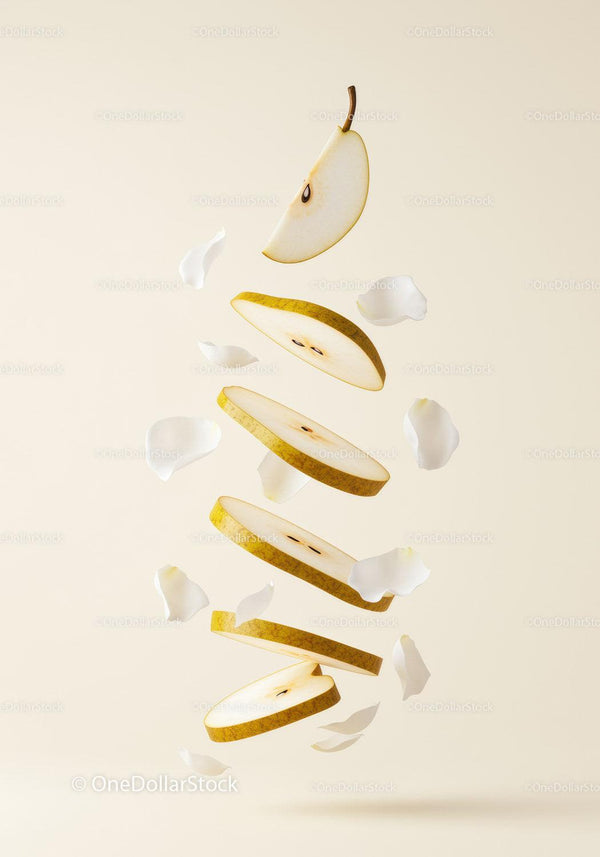 Floating slices of ripe pear with white petals