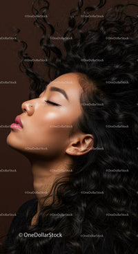 Serene young woman with flowing curly hair profile
