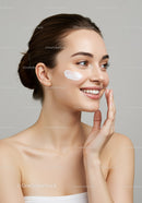 Young Woman Applying Skincare Cream for Healthy Radiant Skin