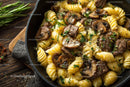 Beef Stroganoff with Mushrooms and Fettuccine on Wooden Table