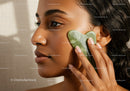 Close-Up of Beautiful Woman with Green Jade Roller for Skincare Treatment