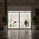 Modern minimalist shopfront with greenery at night