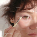 Close-up of Woman Applying Eye Makeup with Brush