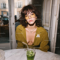 Fashionable Woman with Green Drink in Modern Cafe Setting