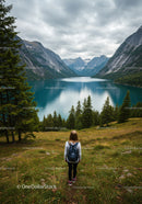 Scenic Mountain Lake with Pine Trees and Woman Hiker