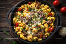 Hearty beef stew with cherry tomatoes and grated cheese in a skillet