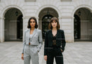 Elegant Businesswomen Standing in Front of Classic City Architecture