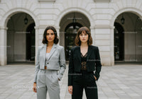 Elegant Businesswomen Standing in Front of Classic City Architecture