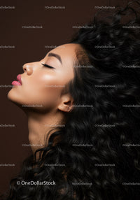 Elegant woman with closed eyes and voluminous curly hair