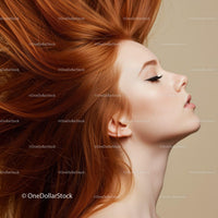 Portrait of serene woman with flowing red hair
