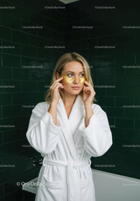 Woman in White Bathrobe Applying Under Eye Masks During Spa Routine