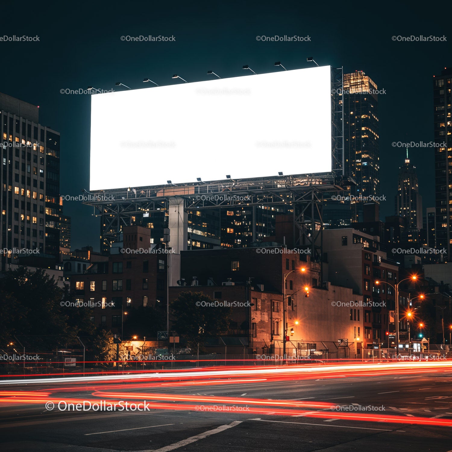 Empty illuminated billboard over city street at night